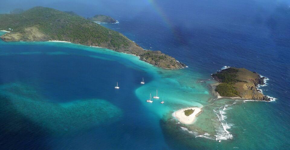 Sandy Spit and Green Cay off Little Jost Van Dyke from the air: a tiny islet of white sand ringed by reef